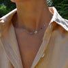 Woman wearing a personalized Virgo & Birthstone necklace on a paperclip link chain featuring a zodiac cutout and gemstone.