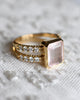 Warren ring with diamonds featuring a 10 x 8mm bezel set Rose Quartz center stone and sixteen prong set accent stones.