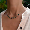 Woman wearing a Grand 8 Connected Birthstone necklace featuring 6mm briolette cut gemstones on a 1.17mm cable chain.