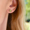 Grand 14k yellow gold stud earrings each featuring one 6 mm briolette cut peridot