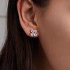 Woman adorned with Greenwich 4 Birthstone earrings in 14k yellow gold featuring four 4 mm white topaz and one 2.1 mm diamond.