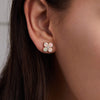 Woman showcasing Greenwich Birthstone Earrings in 14k Gold featuring four 4 mm faceted round cut, prong set Opals and one 2.1 mm  Diamond. 