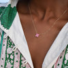Woman wearing a Greenwich 4 Pink Tourmaline necklace featuring four 4mm gemstones and one 2.1mm prong set, center diamond.