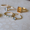 Jewelry including a Greenwich ring featuring one 4 mm Aquamarineand one 2.1 mm diamond prong set in 14k gold