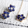 Pair of Greenwich Flower earrings and Greenwich Flower Birthstone Necklace featuring five 4mm sustainably grown sapphires.