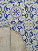 Close-up of ornate tiles on a building featuring white and shades of blue.