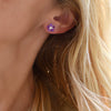 Blond woman wearing HAVERHILL Greenwich 5 Amethyst and Diamond earring with 5 Amethysts each 4 mm surrounding a 2.7mm sustainably grown diamond