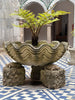 Inner courtyard of the Pena Palace featuring a large, ornate fern planter pot.