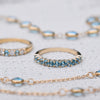 Two Rosecliff Nantucket Blue Topaz Stackable rings, one with alternating diamonds, and a Newport necklace in 14k yellow gold.