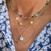 A grandmother wearing a 14k yellow gold personalized Newport necklace, a 4 letter necklace, and a Warren Pendant necklace.