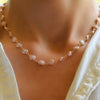 Woman wearing a Newport Grand Pink Opal necklace featuring a continuous strand of 6mm briolette cut, bezel set gemstones.