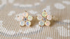Greenwich Flower earrings featuring five 4mm opals and one 2.7mm center diamond, all prong set in 14k yellow gold.