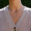 Woman with a Pink Awareness Bayberry necklace featuring eleven 4 mm pink tourmalines & moonstones bezel set in 14k gold