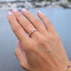 Woman's hand adorned with a Rainbow Rosecliff stackable ring with 2mm rubies, citrines, emeralds, sapphires, amethysts, pink sapphires, and diamonds