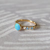 14k gold Rosecliff Grand Ring showcasing a  6 mm round, briolette-cut Turquoise and eight alternating 2 mm round-cut Blue Topazes and Diamonds.