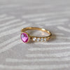 14k gold rings, including a 14k gold Rosecliff Grand Ring with a 6 mm briolette-cut Pink Sapphire and eight smaller 2 mm round-cut Diamonds.