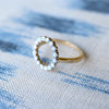 Rosecliff open circle ring featuring sixteen 2 mm faceted round cut aquamarines prong set in 14k yellow gold