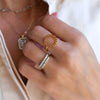 Woman wearing assorted jewelry including a Rosecliff open circle ring featuring sixteen 2 mm citrines prong set in 14k gold