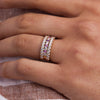 Woman's hand adorned a Rosecliff stackable ring featuring eleven alternating 2mm pink sapphires and diamonds prong set in 14k goldwith