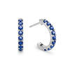 A pair of Rosecliff huggie earrings in 14k white gold each featuring nine 2mm faceted round cut prong set sapphires