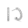 A pair of Rosecliff huggie earrings in 14k white gold each featuring nine 2mm faceted round cut prong set white topaz