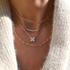 Woman wearing an Adelaide necklace, Rosecliff Bar necklace, Greenwich 4 Birthstone & Diamond necklace, and Newport necklace.