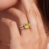 Woman adorned with a 14k yellow gold Warren Horizontal Lemon Verbena Quartz Ring, showcasing an emerald-cut 8 x 10mm Nantucket Blue Topaz, hand-set horizontally in a 14k-gold bezel.