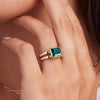 Woman adorned with a 14k yellow gold Warren Horizontal Emerald Ring, showcasing an emerald-cut 8 x 10mm Nantucket Blue Topaz, hand-set horizontally in a 14k-gold bezel.