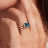 Woman showcasing a 14k yellow gold Warren Horizontal Atlantic Blue Topaz Ring, featuring an Atlantic Blue Topaz-cut 8 x 10mm Nantucket Blue Topaz, hand-set horizontally in a 14k-gold bezel.