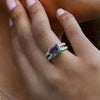 Close-up of a 14k gold Warren Horizontal Alexandrite Ring with Diamonds, showcasing its split-shank band and iridescent gemstone.