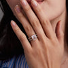 Woman wearing a 14k yellow gold Warren Vertical Ring with accent diamonds featuring one 10 x 8 mm emerald cut bezel set Rose Quartz.