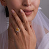 Bride adorned with assorted Haverhill 14k gold rings, including a Warren Vertical Citrine Ring with accent diamonds featuring one 10 x 8 mm emerald cut bezel set citrine.