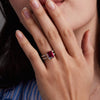 Woman wearing a 14k yellow gold Warren Vertical Ring with accent diamonds featuring one 10 x 8 mm emerald cut bezel set Ruby.