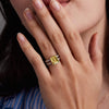 Woman adorned with a 14k yellow gold Warren Vertical Ring with accent diamonds featuring one 10 x 8 mm emerald cut bezel set Lemon Verbena Quartz.