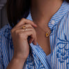 Woman adorned with a 14k yellow gold Warren Vertical Citrine Ring, showcasing one 10 x 8 mm emerald cut, bezel set Citrine in 14k Gold.