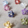 Assortment of Greenwich Flower earrings, all featuring five 4mm gemstones and one 2.7mm sustainably grown diamond.