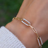 Woman wearing a 14k gold Adelaide paperclip chain pavé bracelet featuring five diamond-encrusted 16 x 6.4mm links.