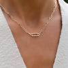 A woman wearing an Adelaide 1 Pavé Link necklace featuring twenty-eight 1.5mm diamonds on an 8.4mm x 2.9mm paperclip chain.