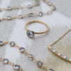 Assorted jewelry including a 1.6 mm wide 14k yellow gold Grand ring featuring one 6 mm briolette cut bezel set aquamarine