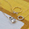 Greenwich 2 Birthstone ring, Warren Pendant, and Rosecliff Small Circle necklace, each featuring white topaz.