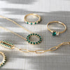 Rosecliff Circle necklace, Greenwich Solitaire ring, Rosecliff ring, & Adelaide 1 Pavé Link bracelet, all featuring emeralds.