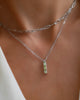 Woman wearing a 14k white gold Adelaide necklace and a Providence pendant featuring three 2x4mm baguette cut gemstones.