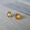 A pair of Stud earring featuring 6 mm briolette cut bezel set Citrine in a 14k yellow gold.