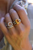 Hand wearing two stacks of rings including a Rosecliff Small Circle ring, two Rosecliff rings, & a Warren ring with diamonds.