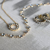 A Rosecliff Small Circle necklace, a Newport necklace, and Rosecliff earrings, all featuring sustainably grown Aquamarines.