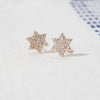 A pair og Diamond Star of David Stud Earrings in Solid 14k white Gold, featuring thirty-seven 1mm faceted round cut, prong set, Diamonds.