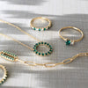 Jewelry including a Greenwich ring featuring one 4 mm emerald and one 2.1 mm diamond prong set in 14k gold