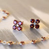 Greenwich Birthstone Earrings in 14k Gold featuring four 4 mm faceted round cut, prong set Garnets and one 2.1 mm  Diamond. 