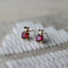 Pair of 14k yellow gold Greenwich Solitaire earrings, each featuring a 4mm sustainably grown ruby and one 2.1mm diamond.