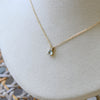 Greenwich Solitaire necklace in 14k yellow gold featuring one 4mm aquamarine and one 2.1mm diamond on a 1.17mm cable chain.